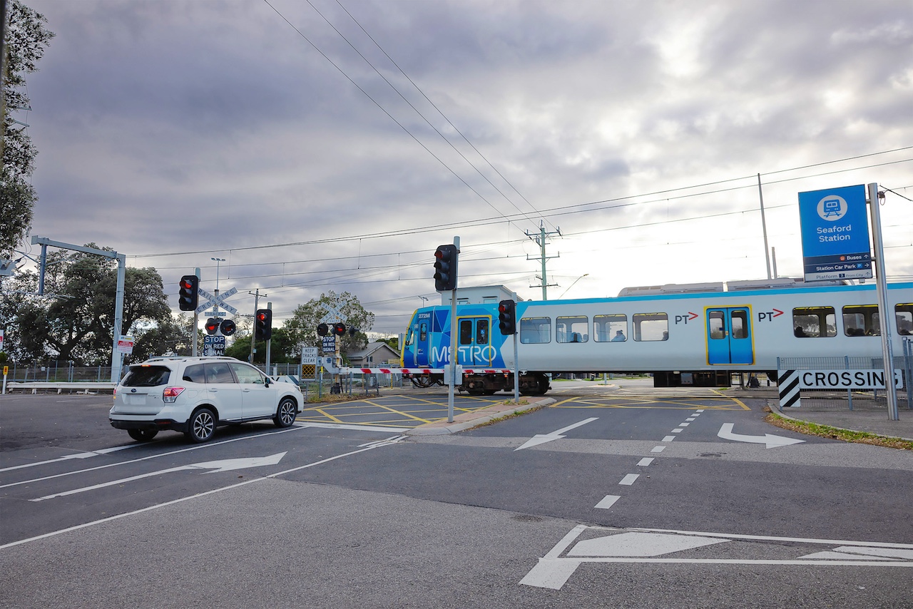 A train passing through the Seaford Station level crossing