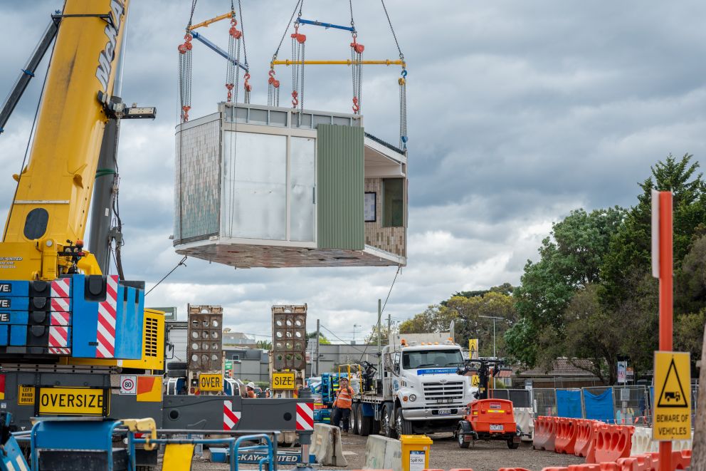 A pre-fabricated Mordialloc Station waiting room module being lifted up by crane