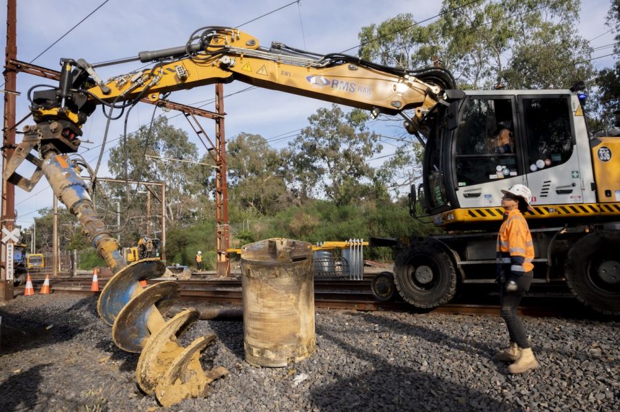 Excavator with drill attachment