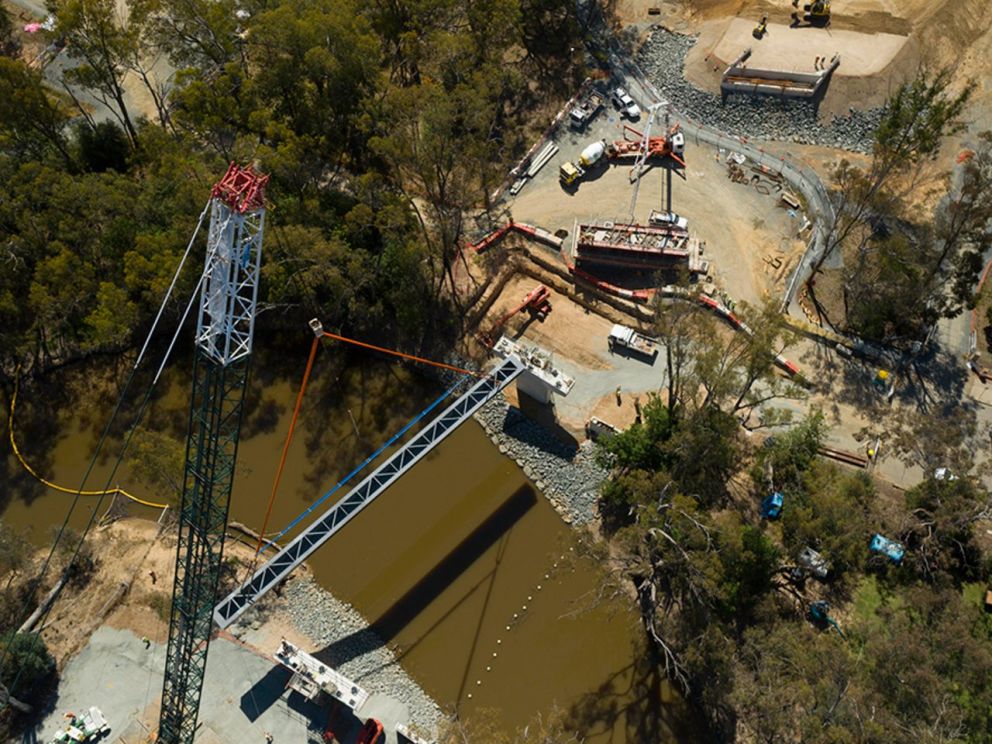 Birds eye image of a steel beam being lifted in place for the Campaspe River bridge