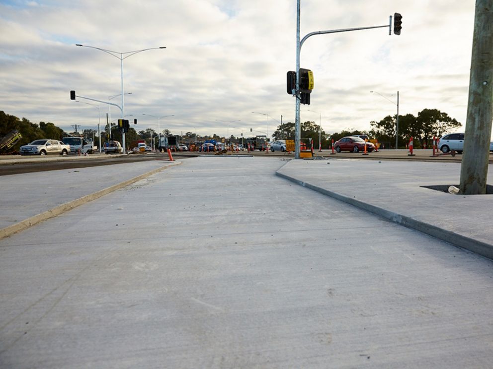 Image of the road and traffic island along each side.Diverted traffic can also seen in the background