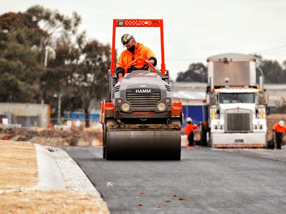 Continuing to lay asphalt for the exit ramp onto Woodlands Drive