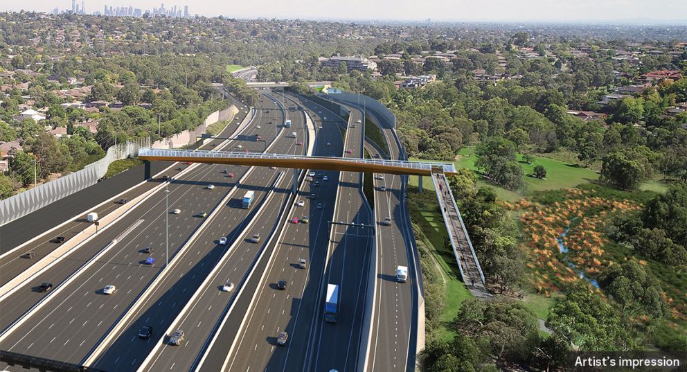 An artist impression aerial view of the bridge over the Eastern Freeway at Lyndhurst facing south with the city skyline in the background.