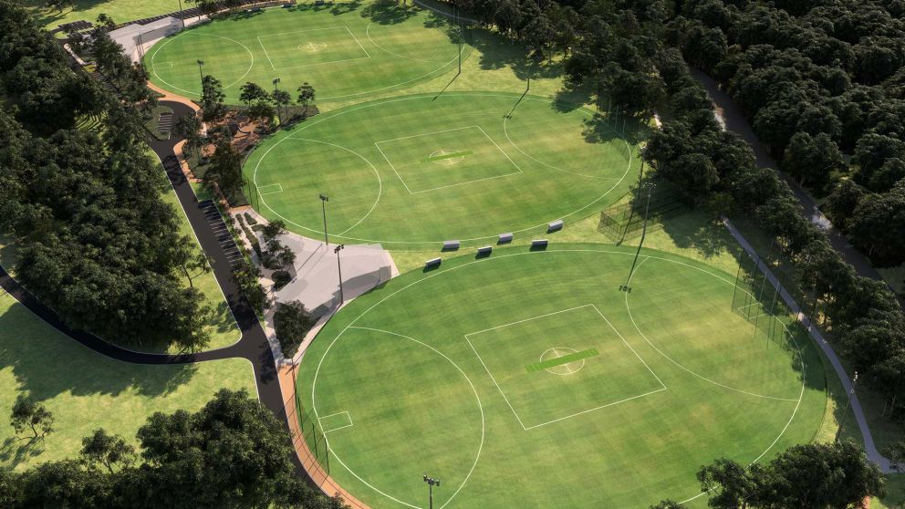 Aerial artist impression of Bulleen Park sporting facilities including 3 sports ovals with field lights and cricket nets, surrounded by trees and a car park adjacent to the ovals.