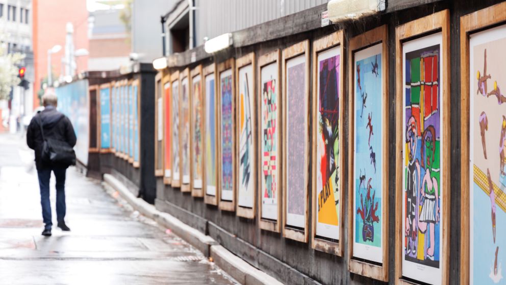 View of colourful artworks in frames along the hoardings on Franklin Street