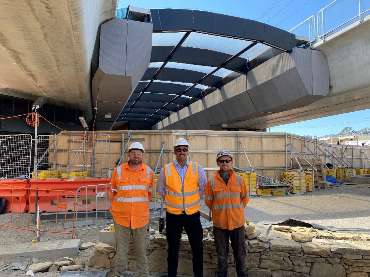 Three workers in hi-vis standing at Mooroolbark Station