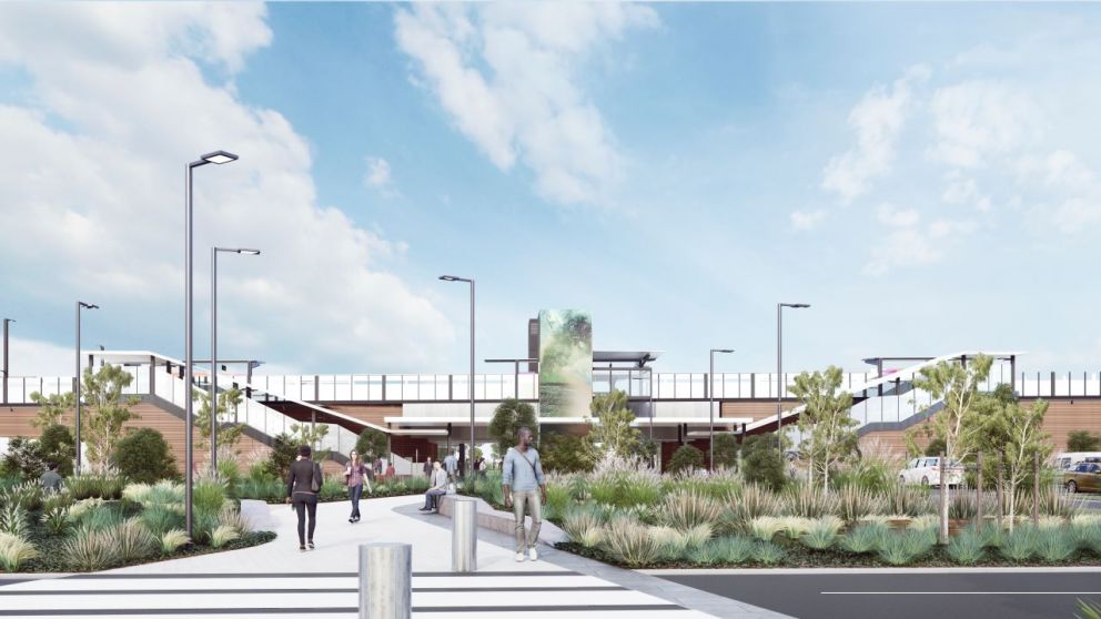 Artist's render of the southern entrance to the new Deer Park Station. In the foreground there are landscaped gardens and a pedestrian path leading to the station building. In the background we see the new Deer Park Station, with stairs leading up to the platforms on both sides.