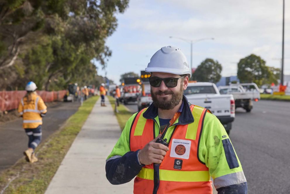 Preparing the surface of the Nepean Hwy bike path for asphalting. A Native Oz contractor is working on traffic management to keep traffic moving and ensure the safety of workers.