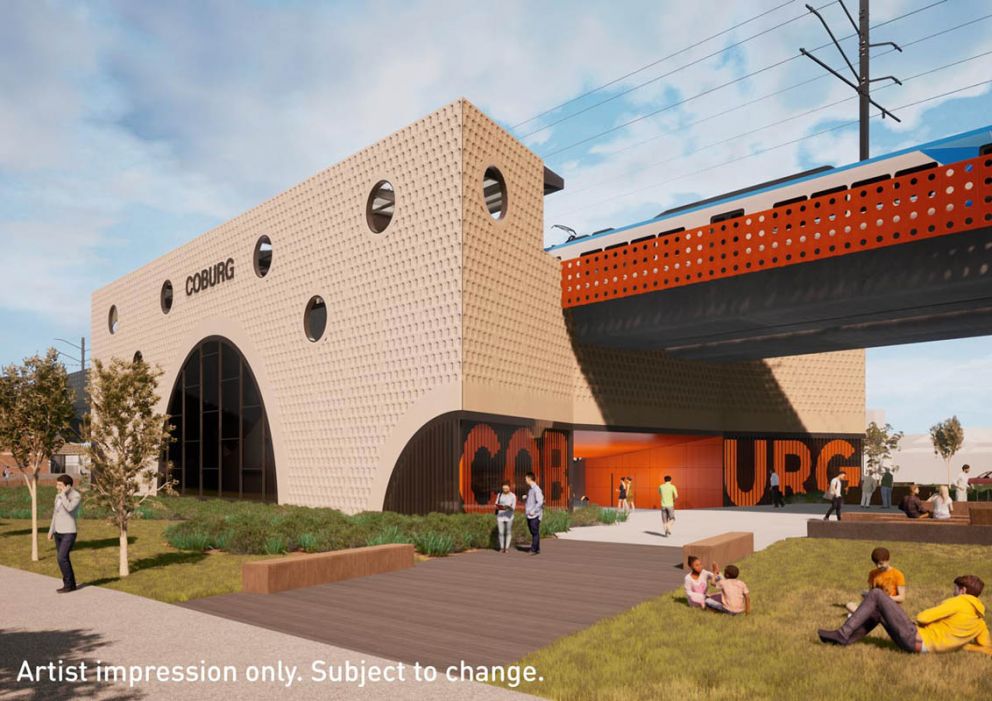 Large square building with orange rail bridge