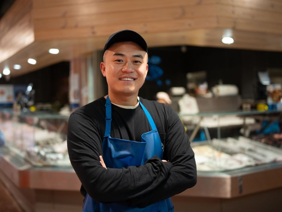 Alvin - Business owner standing in front of market stall