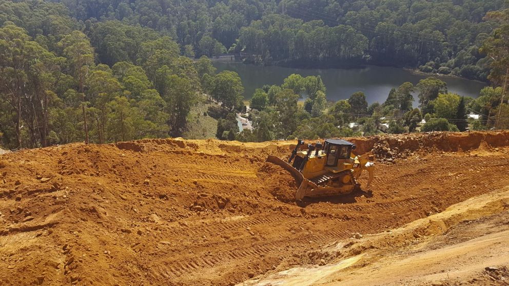 D8 Bulldozer pushes material on top of the landslip 9 March