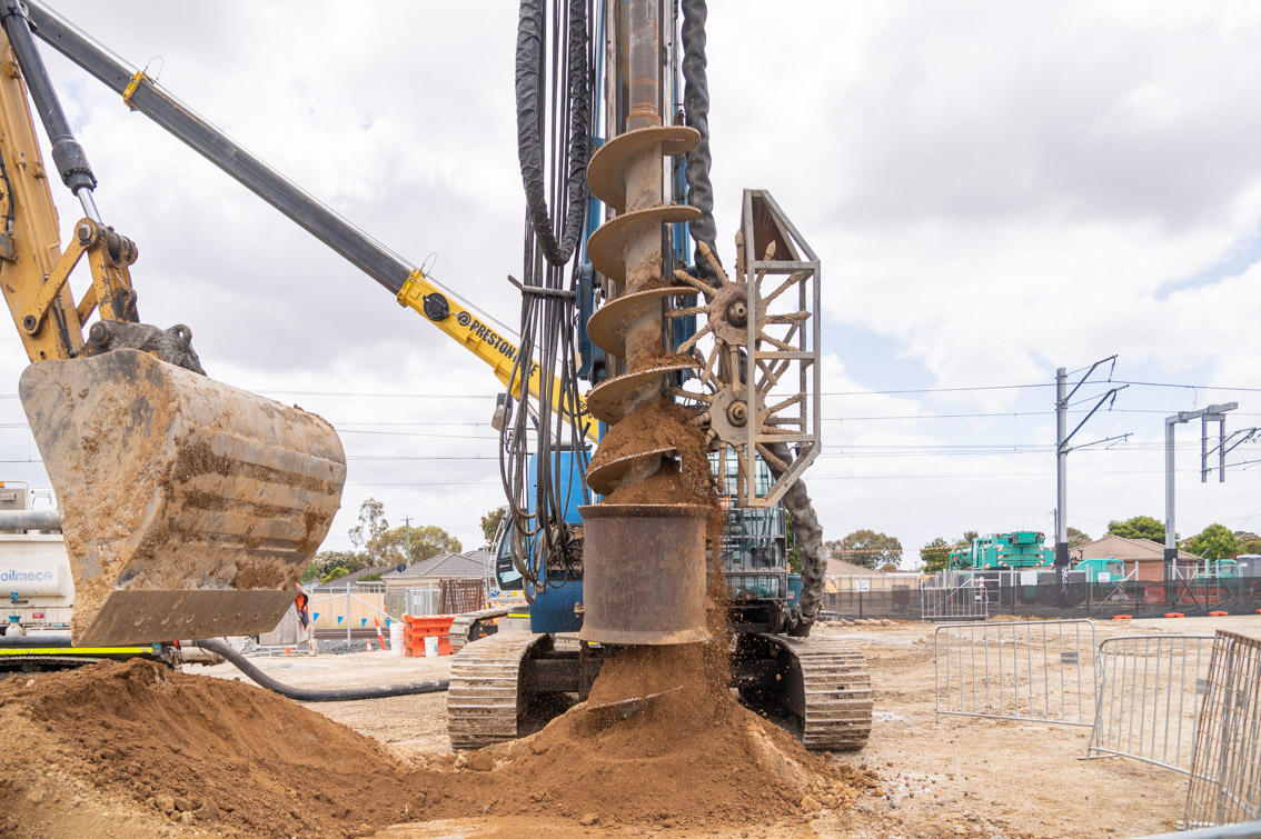 Piling rig drilling into the ground.