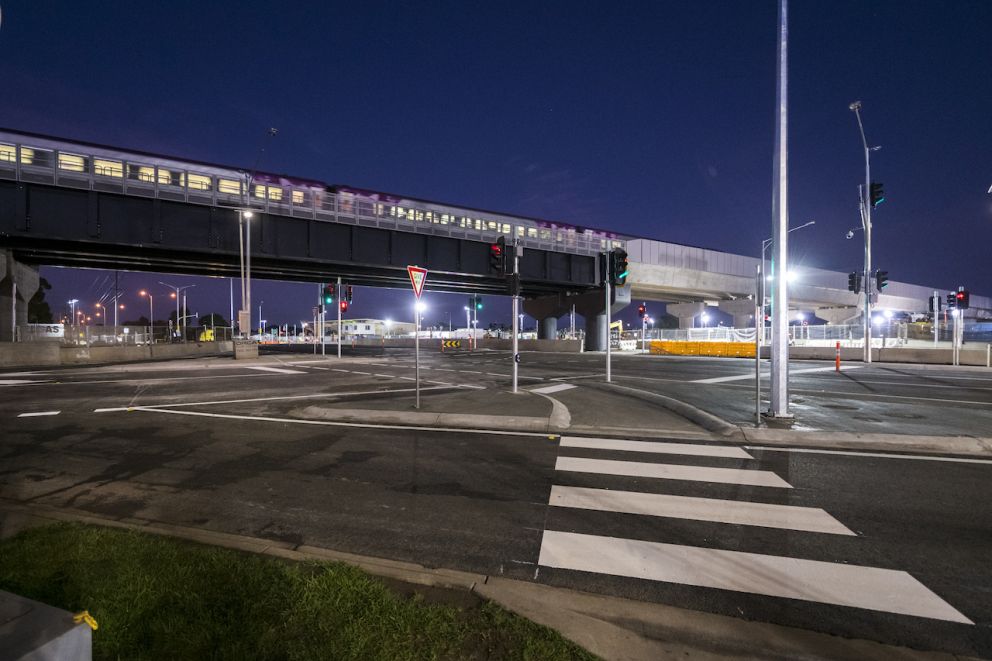 A V/Line train travels across the new elevated rail line above Mt Derrimut Road.