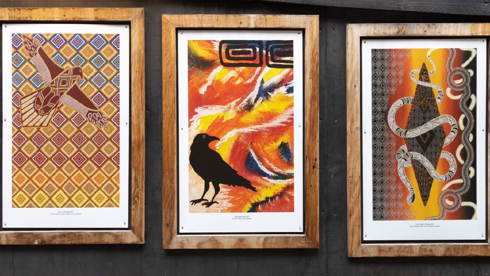 Image of three wooden frames displaying artworks by First Nations artists