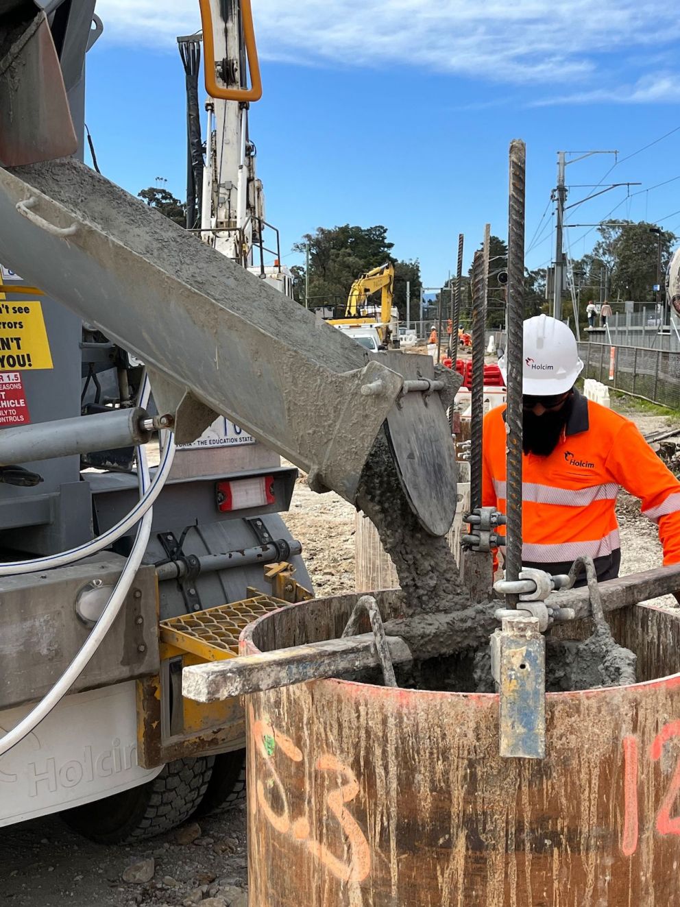 Workers pouring cement into foundations