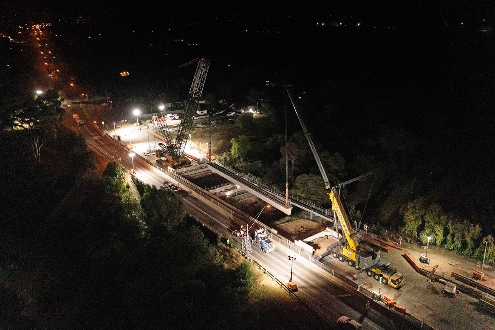 The beams were delivered to site, then lifted from its transport onto the bridge