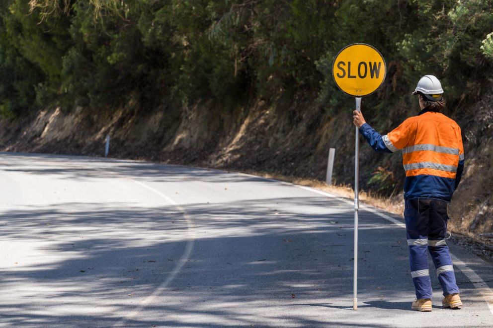Traffic controller helping to guide traffic during works