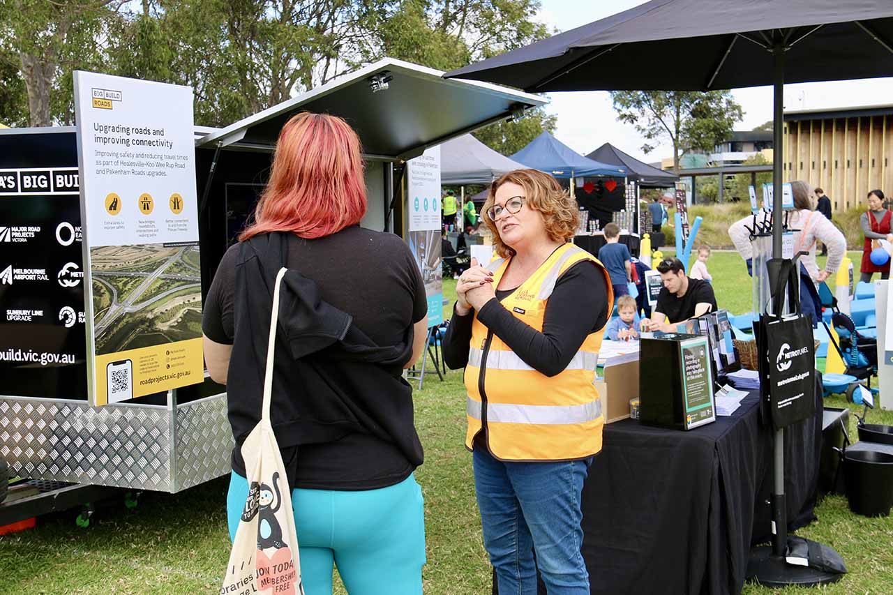 Two women talking at the information stand at Yakkerboo Festival 