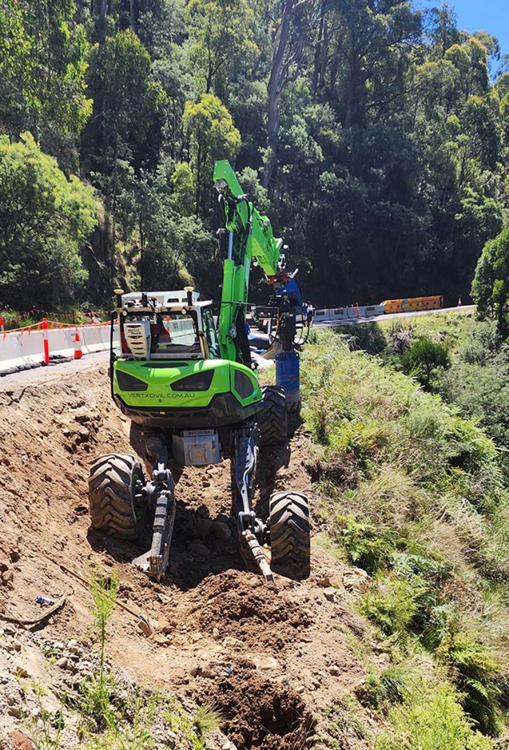 The nibble spider excavator skillfuly balances on the edge of Boong High Plains Road at the second smaller landslip