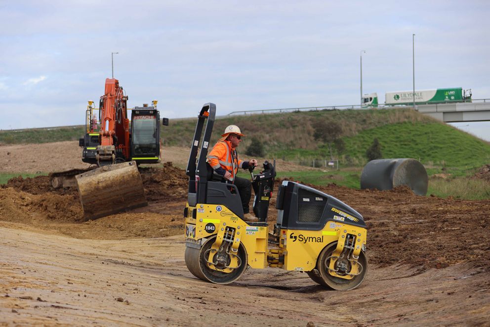 May 2023- A compactor flattening soil to build up the new freeway ramps at McGregor Road