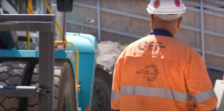 Construction worker wearing high vis top and white hard hat