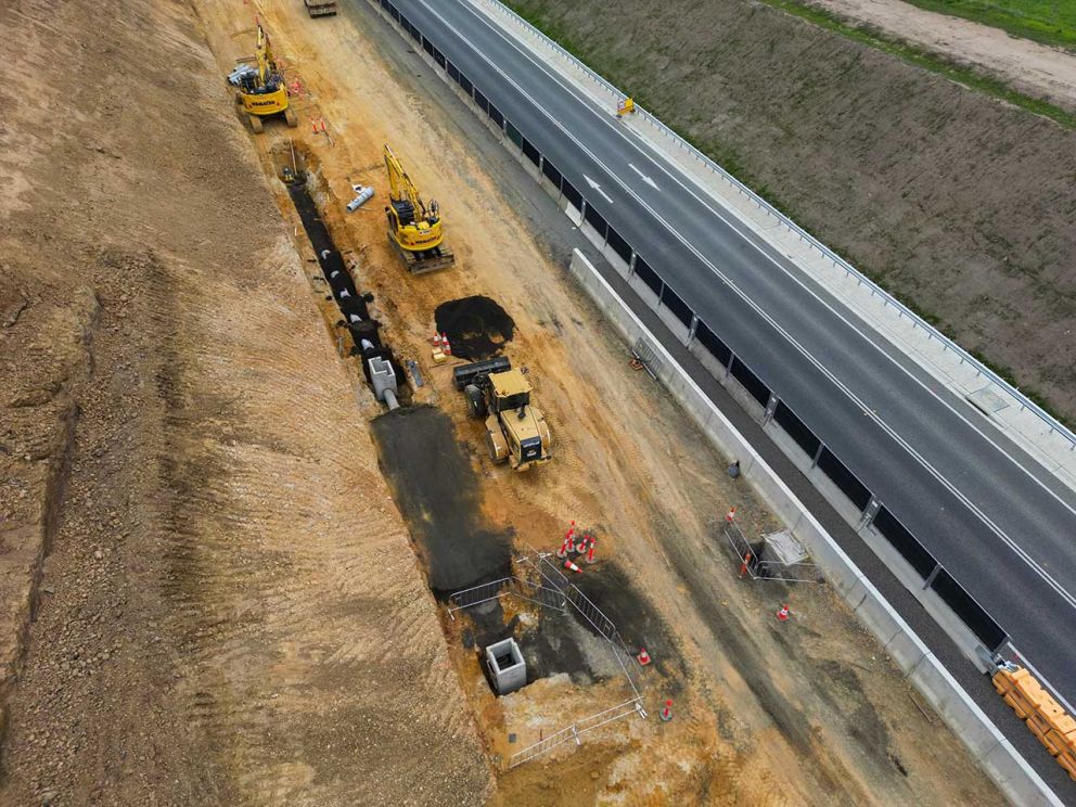 A glimpse of new lanes being constructed behind barriers