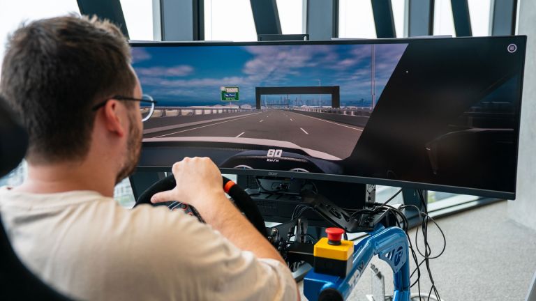 A man test drives the simulator to explore his trip options.