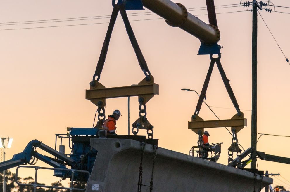 Workers get ready to lift the first beam into place at Melton