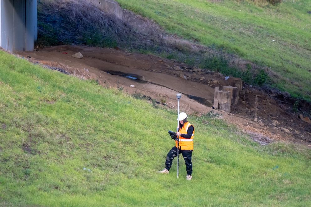 Crews conducting survey works by Dandenong Creek for the Webster Street level crossing removal