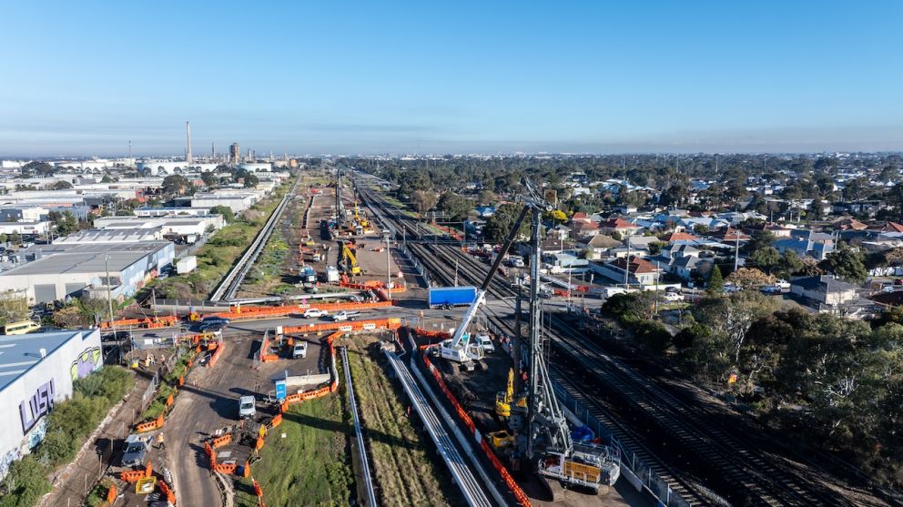 Two piling rigs drilling deep for the foundations of the rail bridges