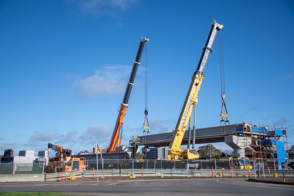 Two cranes installing L-beams at Coburns Road in Melton