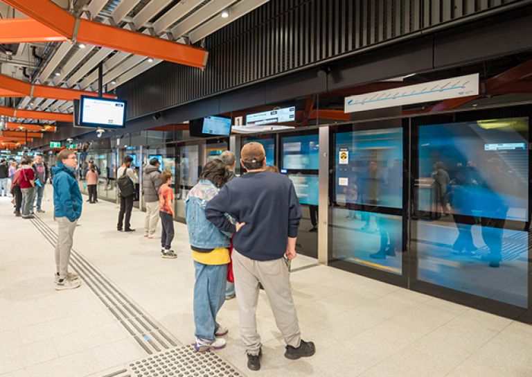 Passengers wait to board a train in the Metro Tunnel