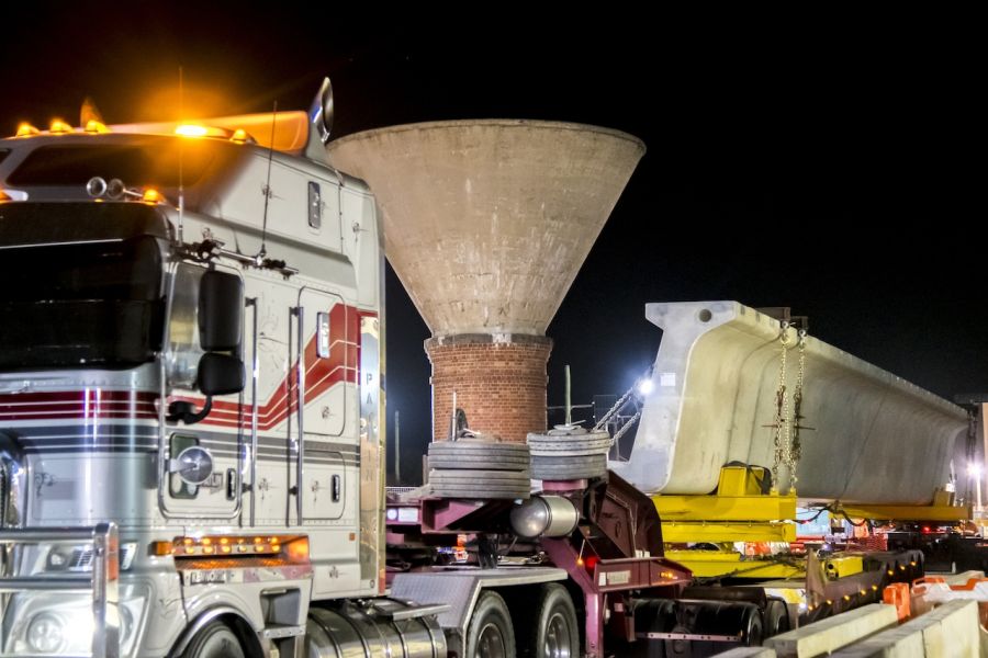 A specialised vehicle transporting an L Beam with precision through Mordialloc