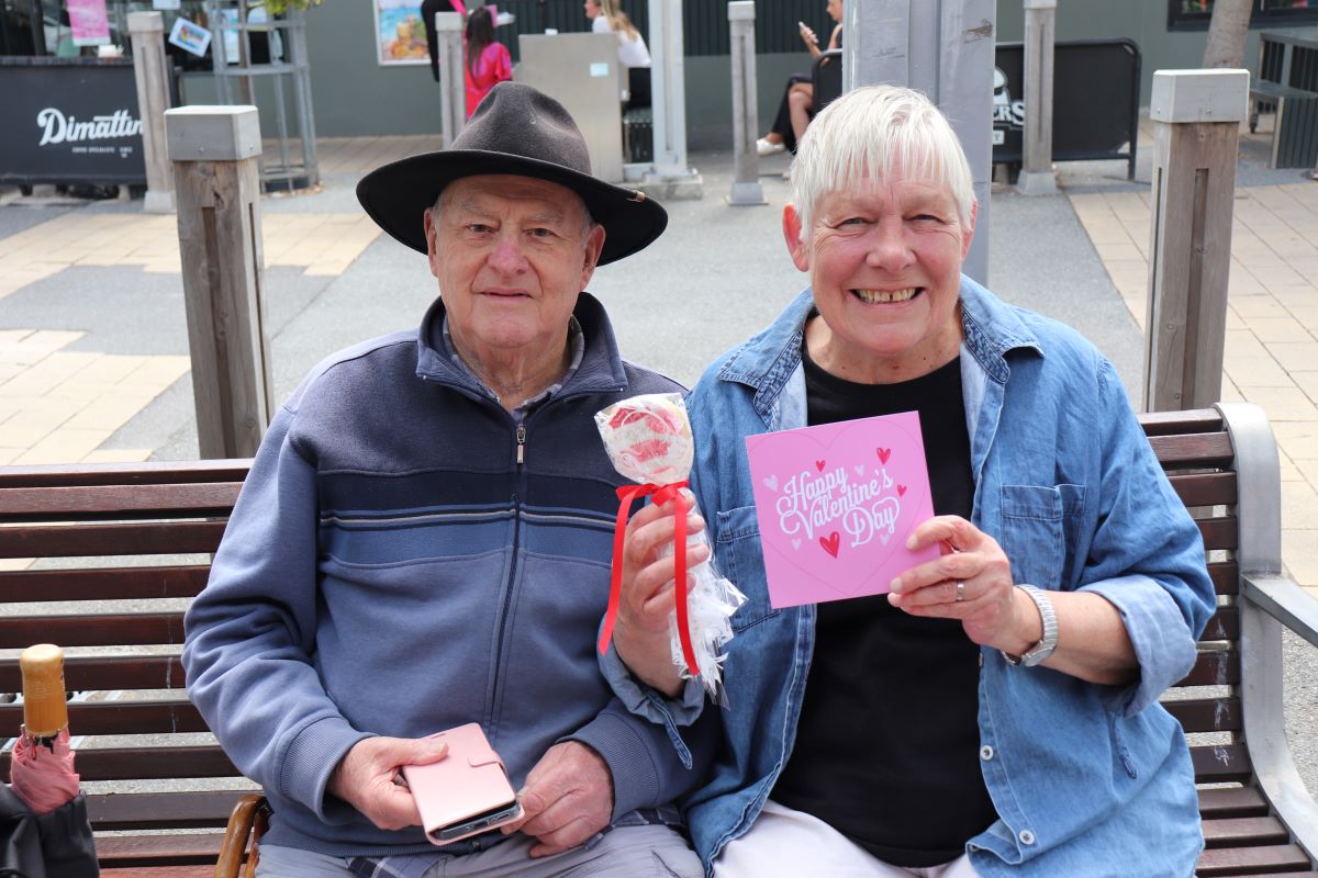 Two lucky locals enjoying a free cookie