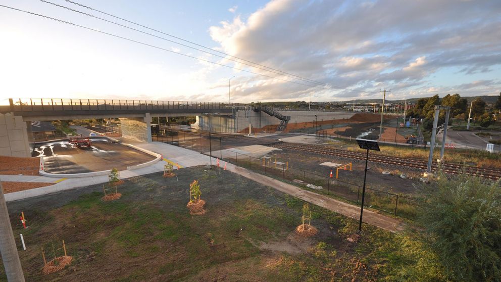 A train crosses under the partially constructed Cardinia Road bridge.
