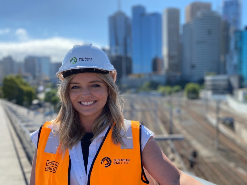 Cody Phelan wearing a hard hat with Melbourne CBD in background