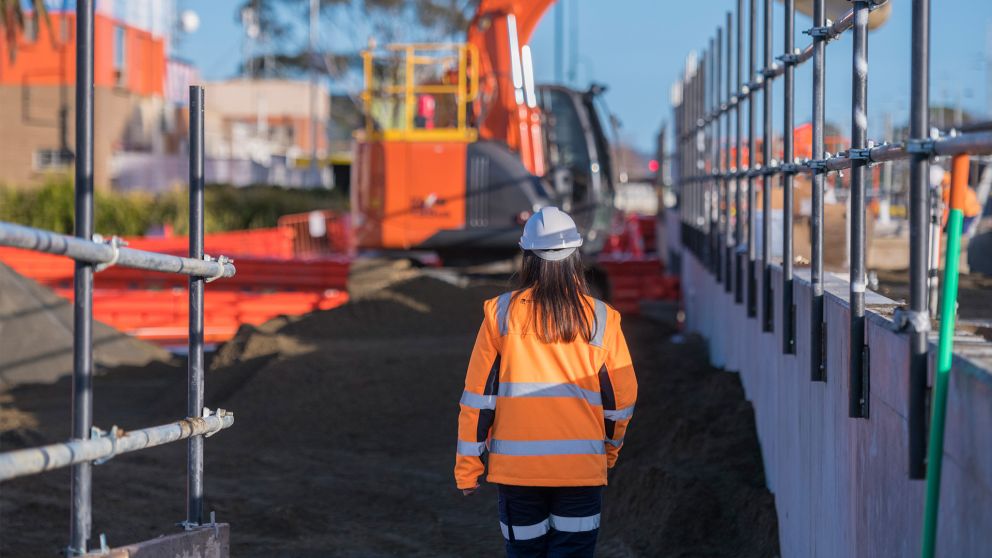Person walking towards construction on-site