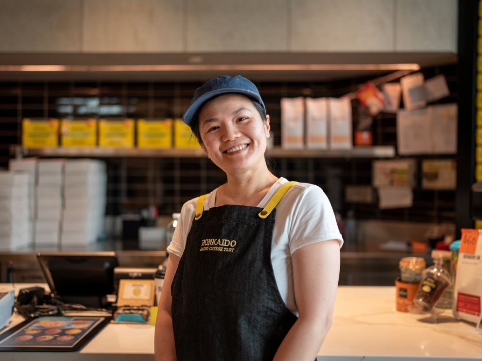 Joyce - Baker standing in front of store counter