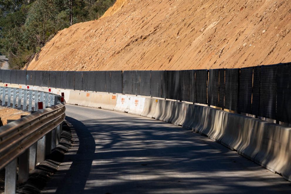 Concrete barriers and anti-gawk screens are established across the face of the landslip 14 April