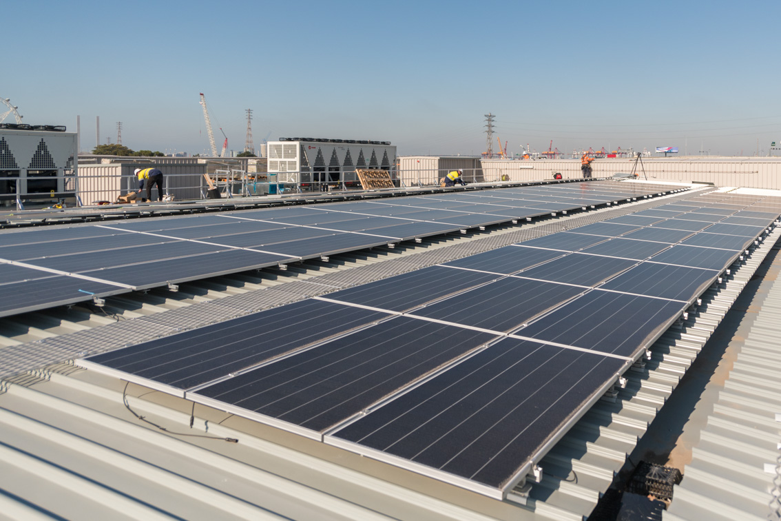 Two rows of solar panels on the Arden Station entrance roof.