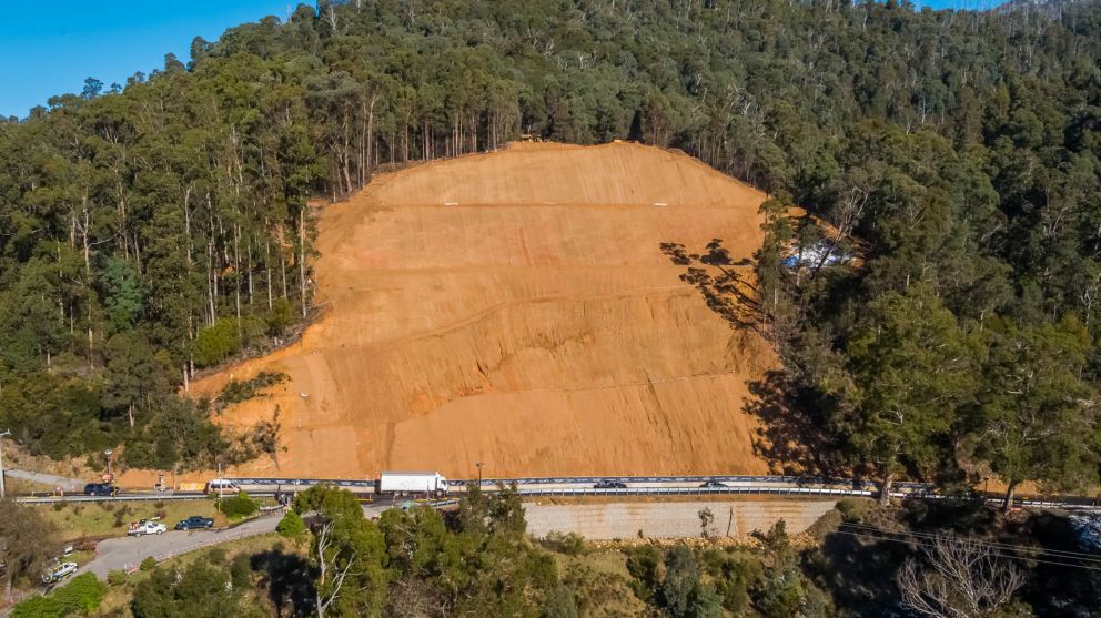 Vehicles passing across the front of the Bogong High Plains Rdlandslip