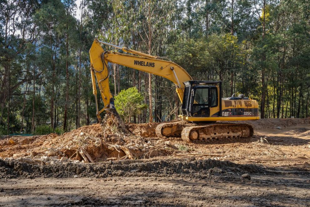 Excavator clearing material