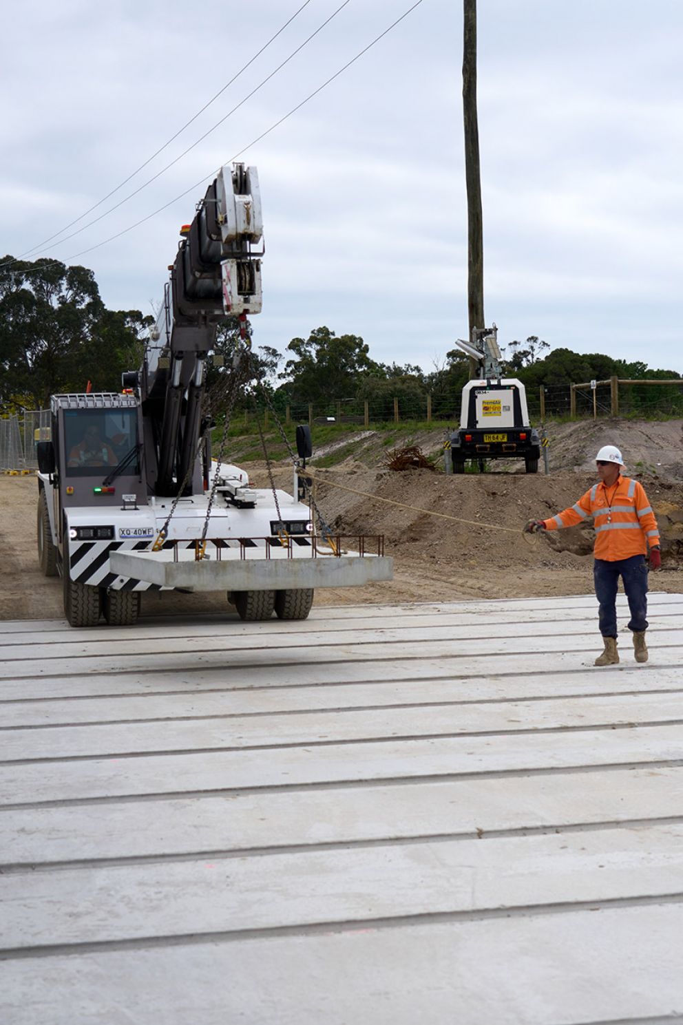 Crew guiding in a link slab for new culvert installation