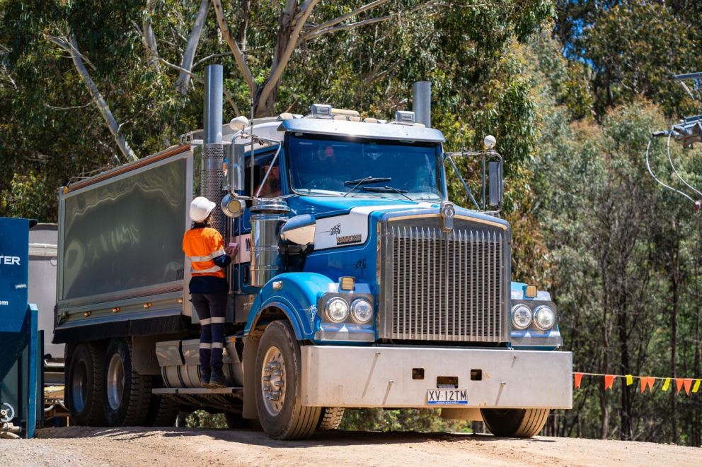 Trucks prepare to continue carting material from the landslip