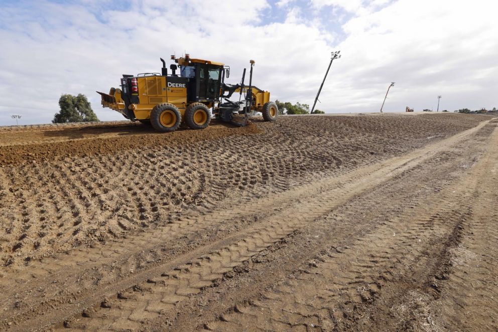 Earthworks to build the verge on the side of the widened ramp.