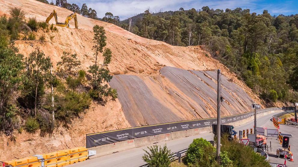 An excavator works on the middle bench of the landslip