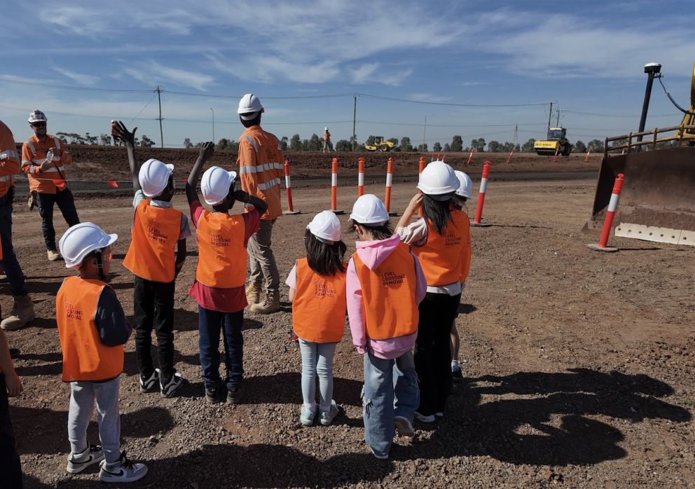 Attendees waving to the big machines on site