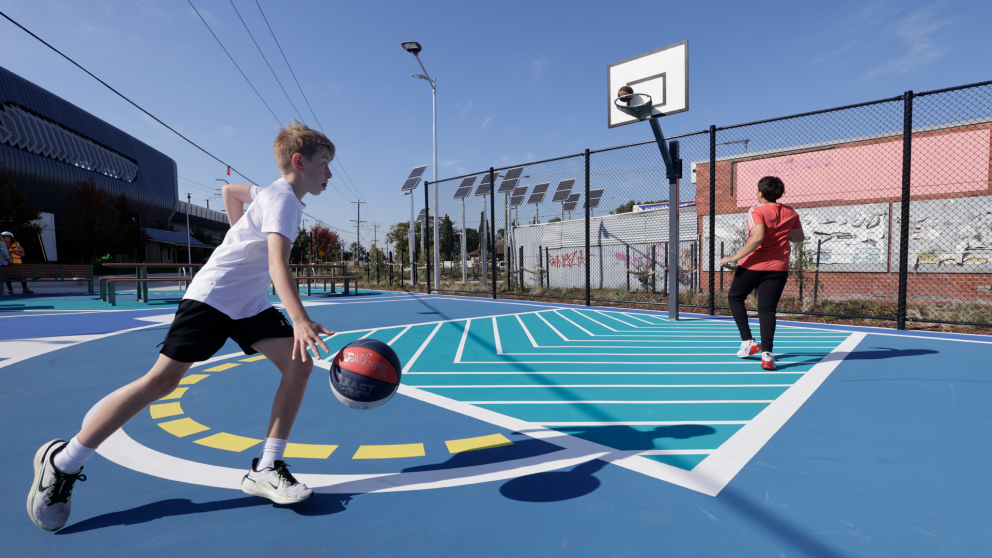 Kids playing basketball in Claytons new open space.