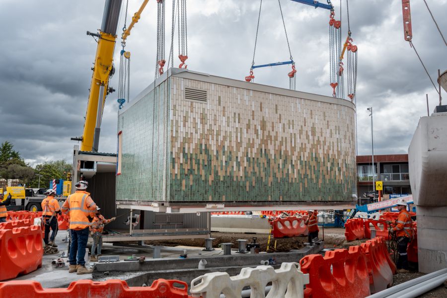 The pre-fabricated waiting room lifted by crane, featuring native-coloured subway tiling