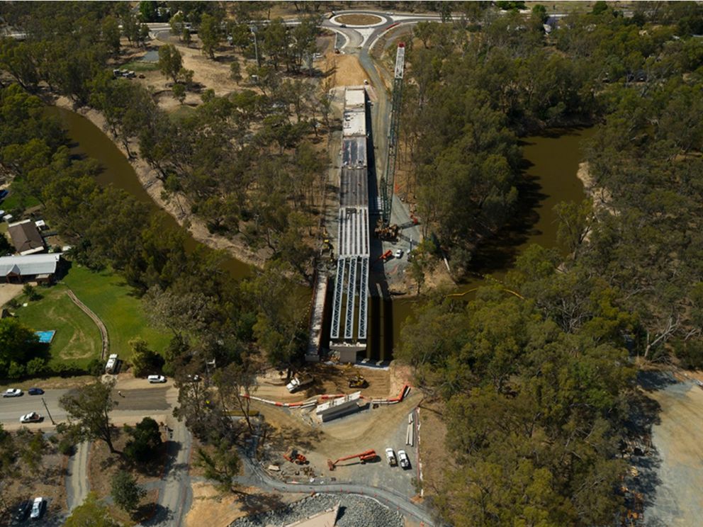 Birds eye image of the Campaspe River bridge looking towards Warren St, with nature and housing along either side of the river